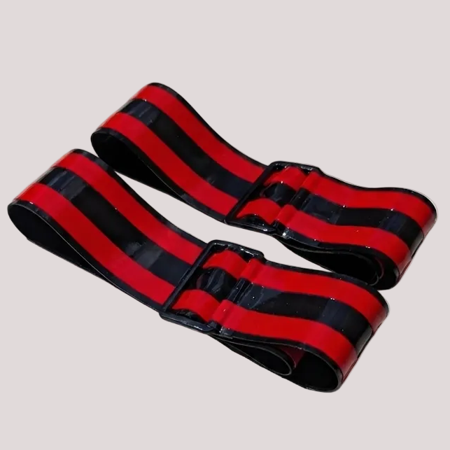 Two red and black striped elastic bands with black plastic buckle closures, shown on a light gray background.