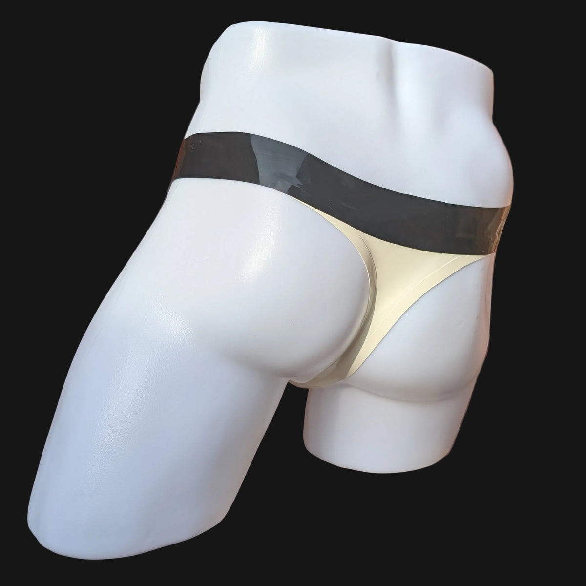 A white mannequin lower torso wearing a white thong-style underwear piece with a black waistband